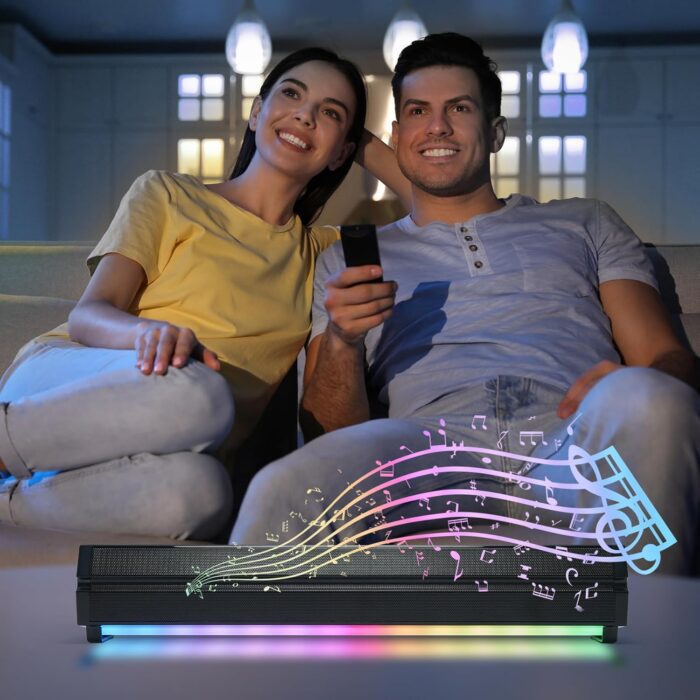 Couple watching TV with colorful soundbar.