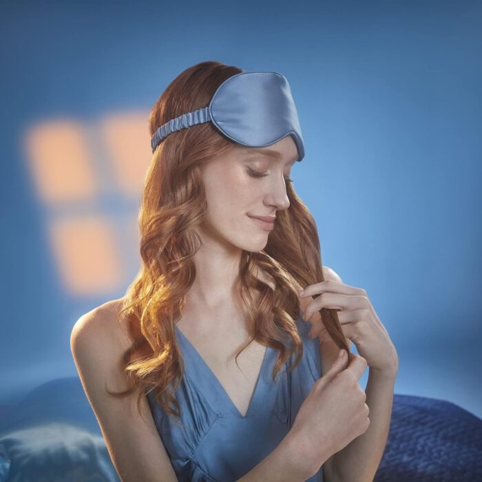 Woman wearing blue sleep mask and dress