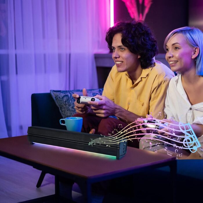 Couple gaming with soundbar on table