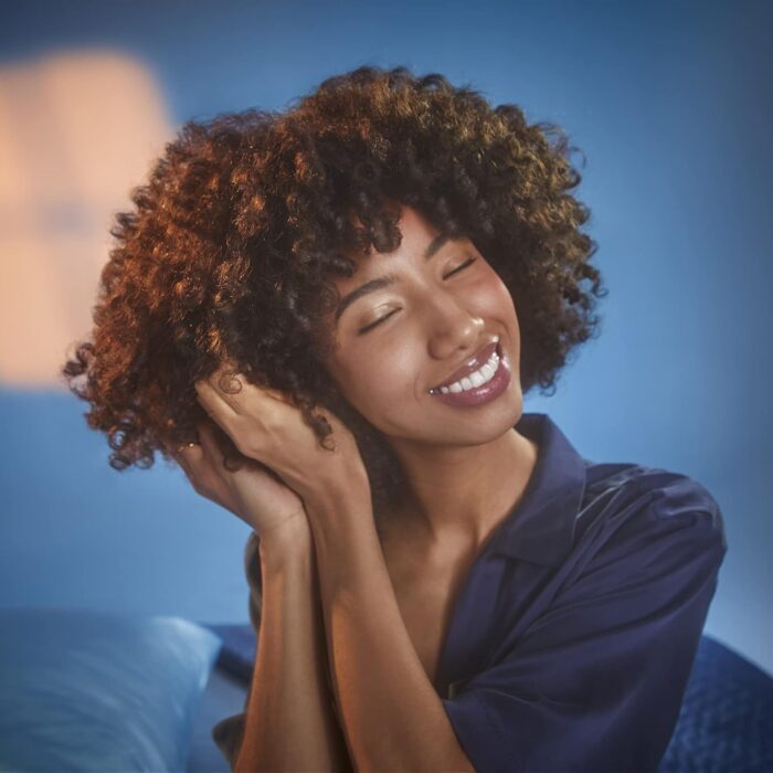 Smiling woman with curly hair enjoying the moment